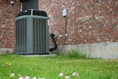 residential air conditioning unit outside of a brick home