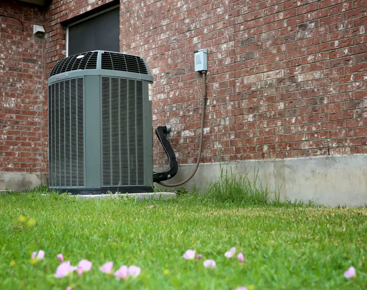 residential air conditioning unit outside of a brick home