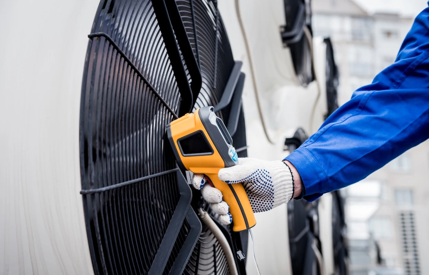 Technician using a temperature sensor to test a heat pump.